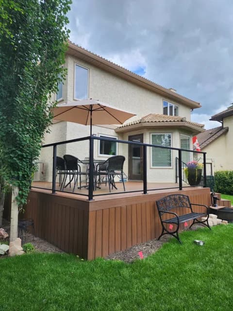 DHI completed deck with glass railings and outdoor seating